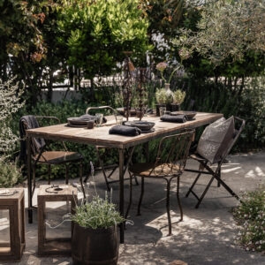 Reclaimed wood outdoor dining table surrounded by lavender garden, styled with handmade ceramics and stoneware vase — Soulosofie Mallorca