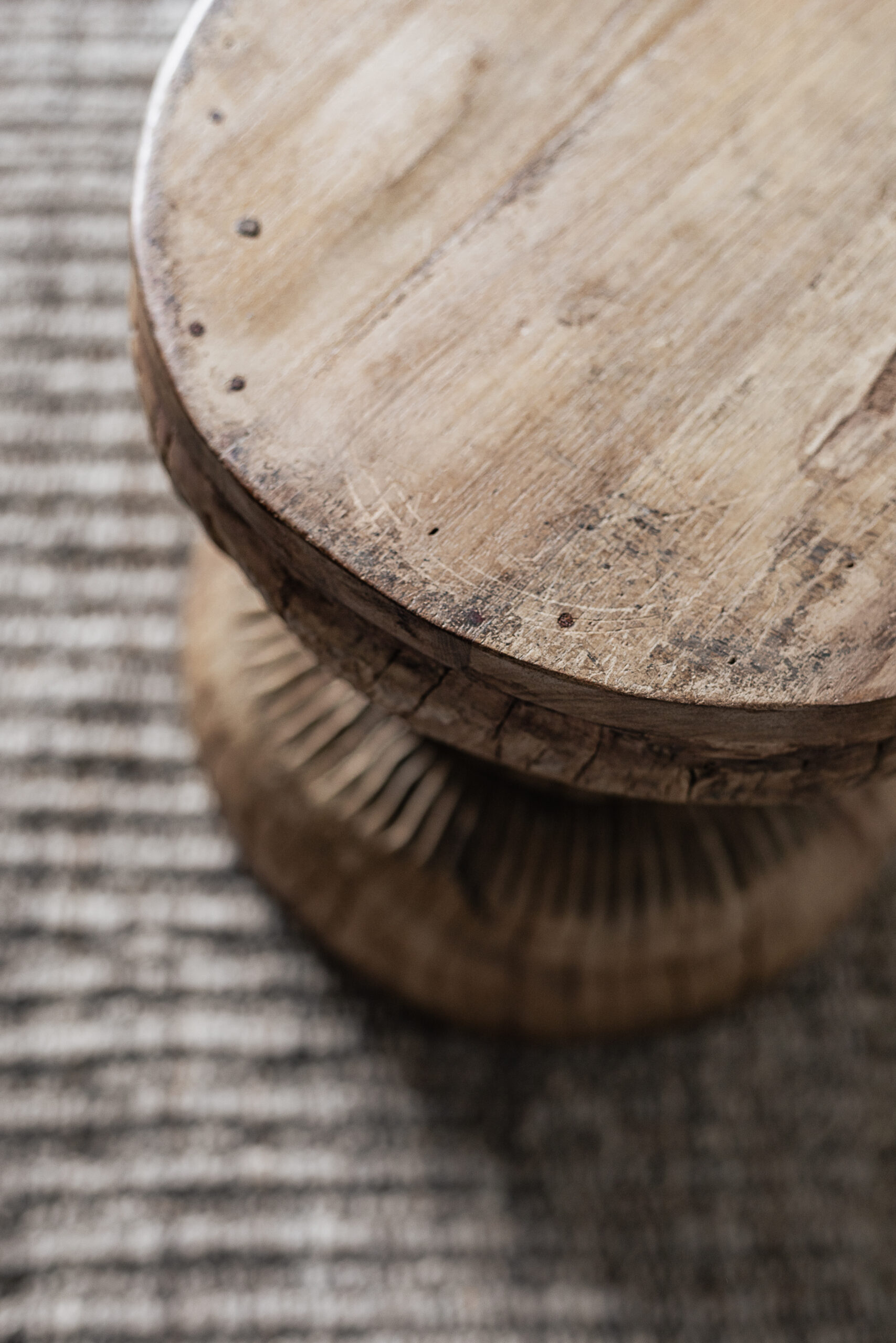 Vintage carved wood stool with hand-carved sunburst detail and natural worn finish — Soulosofie Mallorca
