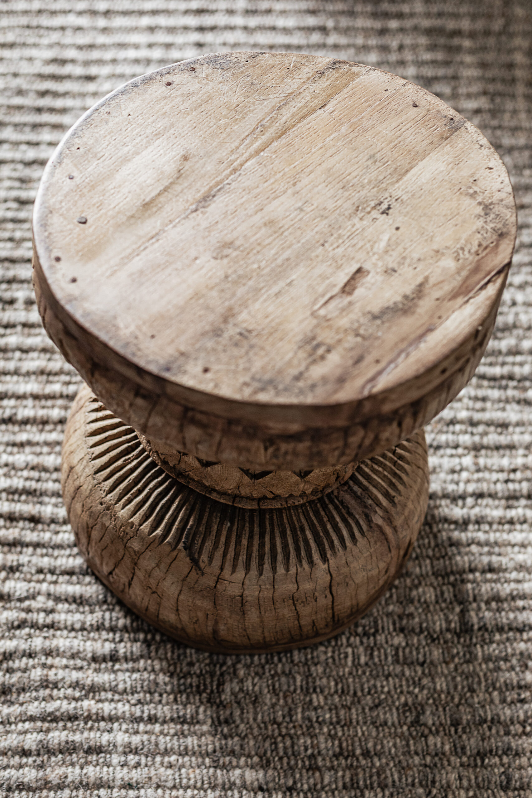 Vintage carved wood stool with hand-carved sunburst detail and natural worn finish — Soulosofie Mallorca