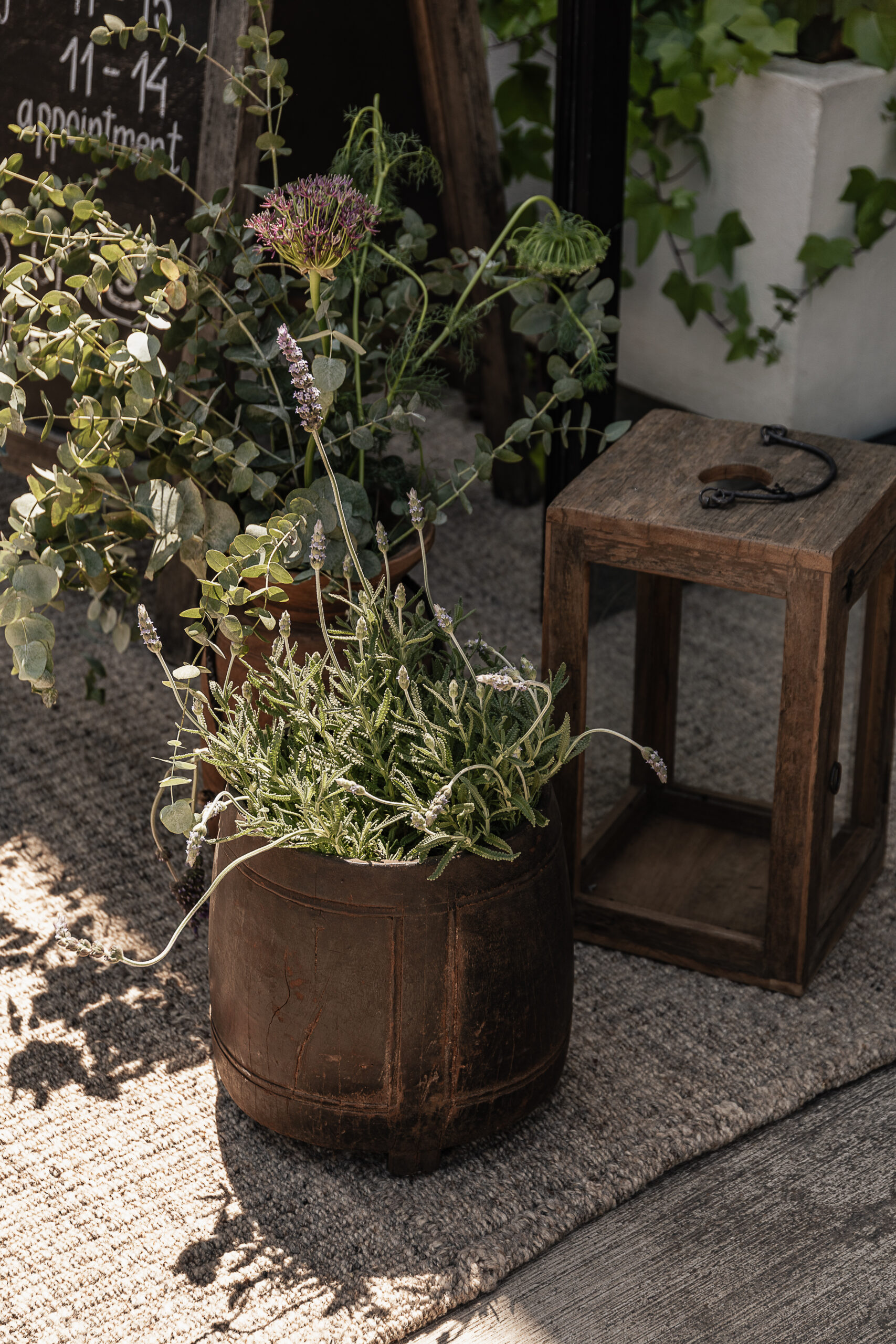 Vintage large wooden pot used as an outdoor planter with lavender, styled in a Mediterranean garden — Soulosofie Mallorca