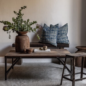 Reclaimed wood sofa table with iron legs, styled with vintage clay pot and indigo cushions — Soulosofie Mallorca