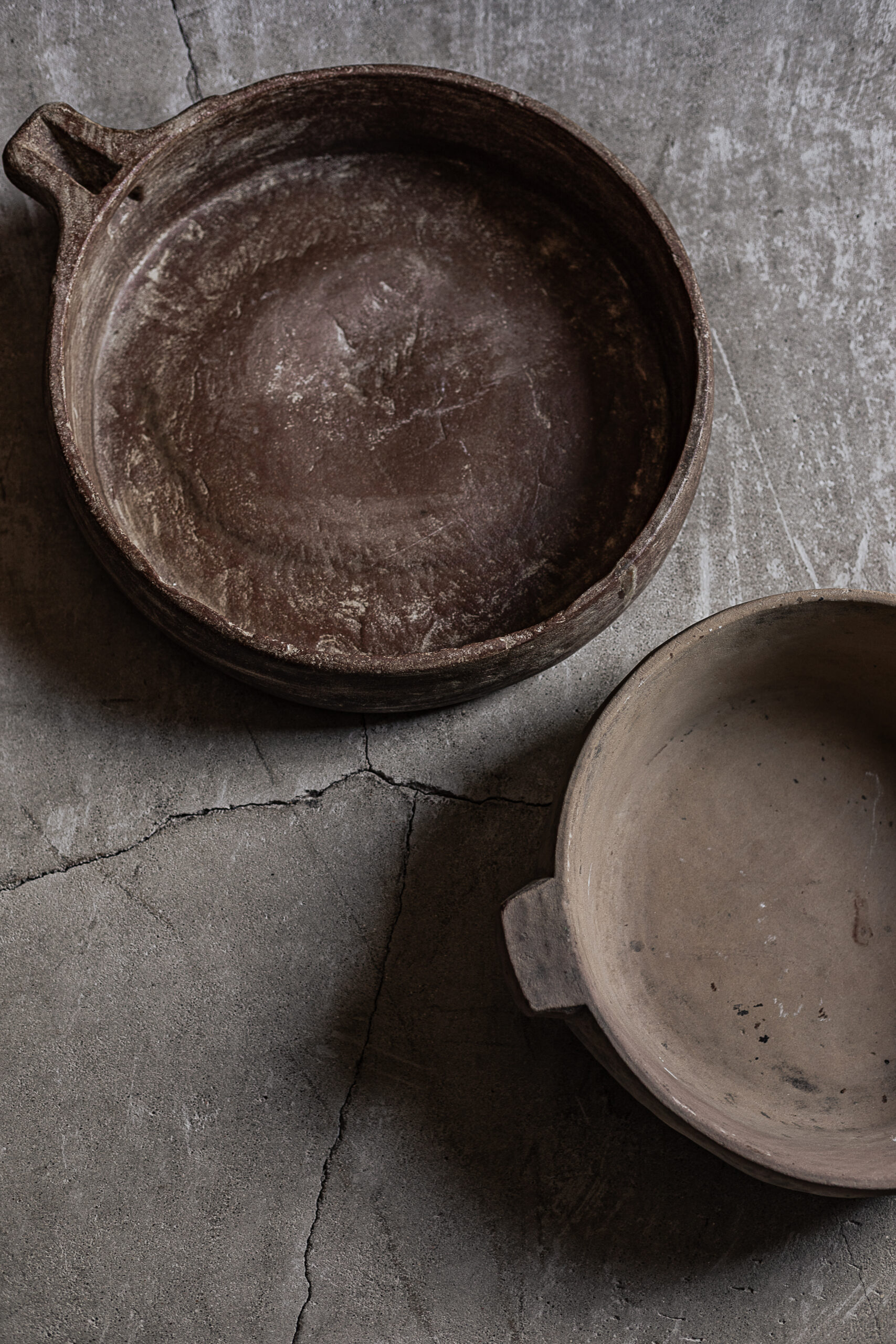 Vintage stone bowls with raw natural finish, small handled bowl alongside large round bowl — Soulosofie Mallorca