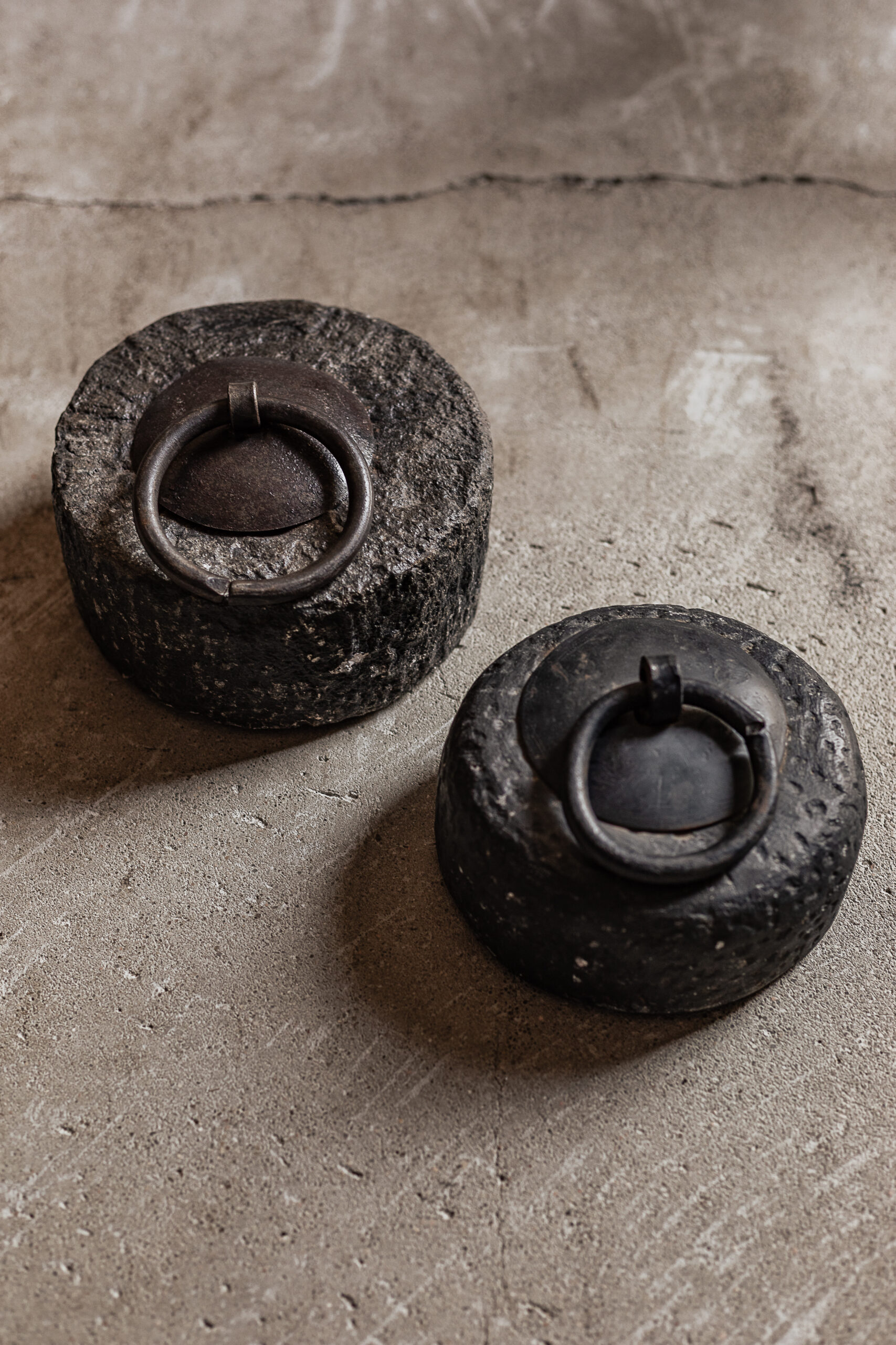 vintage stone door stopper with antique iron ring, raw textured surface — Soulosofie Mallorca