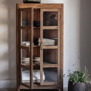 Vintage teak narrow glass door display cabinet with open shelves, styled with folded linen textiles and ceramics — Soulosofie Mallorca